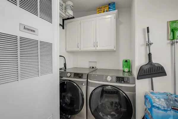 a utility room with sink dryer and washer
