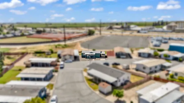 an aerial view of a house and a yard