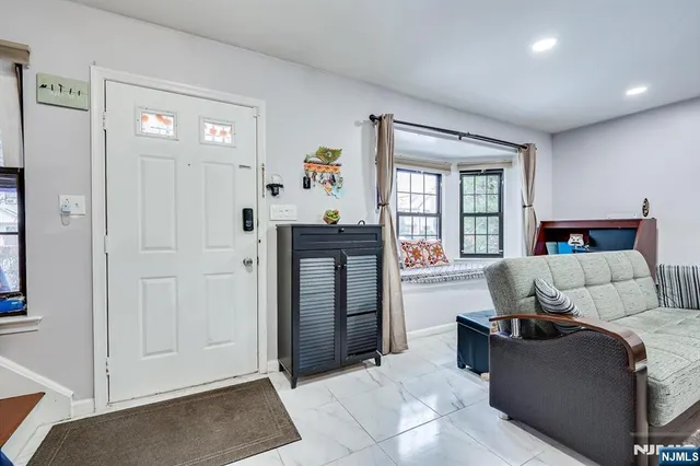 a living room with furniture and a dining table with potted plant