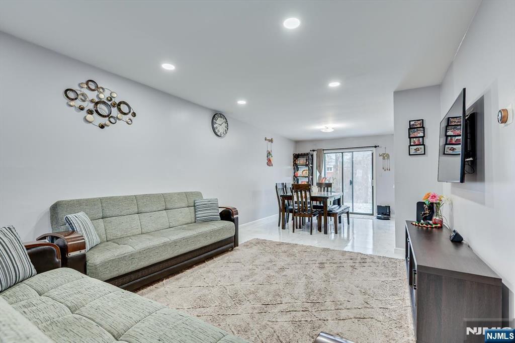 304 Maplecrest Road, Unit 304 Edison, NJ 08820 - Photo 12 of 38 a living room with furniture and a dining table with potted plant