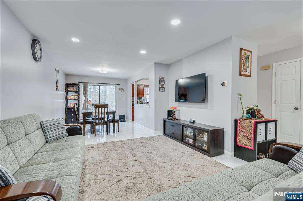 304 Maplecrest Road, Unit 304 Edison, NJ 08820 - Photo 13 of 38 a living room with furniture and a flat screen tv