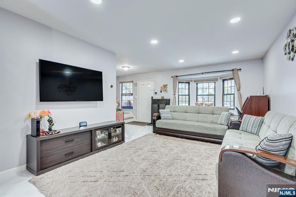 304 Maplecrest Road, Unit 304 Edison, NJ 08820 - Photo 14 of 38 a living room with furniture and a flat screen tv