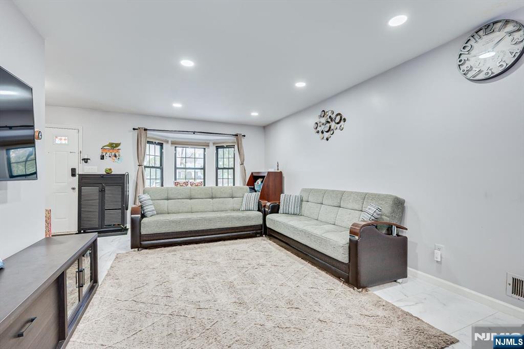 304 Maplecrest Road, Unit 304 Edison, NJ 08820 - Photo 15 of 38 a living room with furniture and a wooden floor