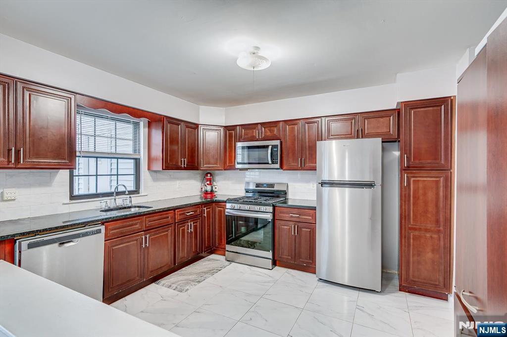 304 Maplecrest Road, Unit 304 Edison, NJ 08820 - Photo 19 of 38 a kitchen with stainless steel appliances granite countertop a refrigerator stove top oven and sink