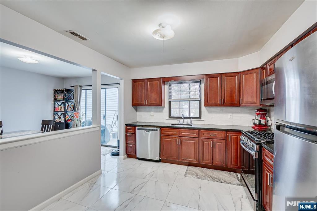 304 Maplecrest Road, Unit 304 Edison, NJ 08820 - Photo 21 of 38 a kitchen with stainless steel appliances granite countertop a refrigerator sink and cabinets