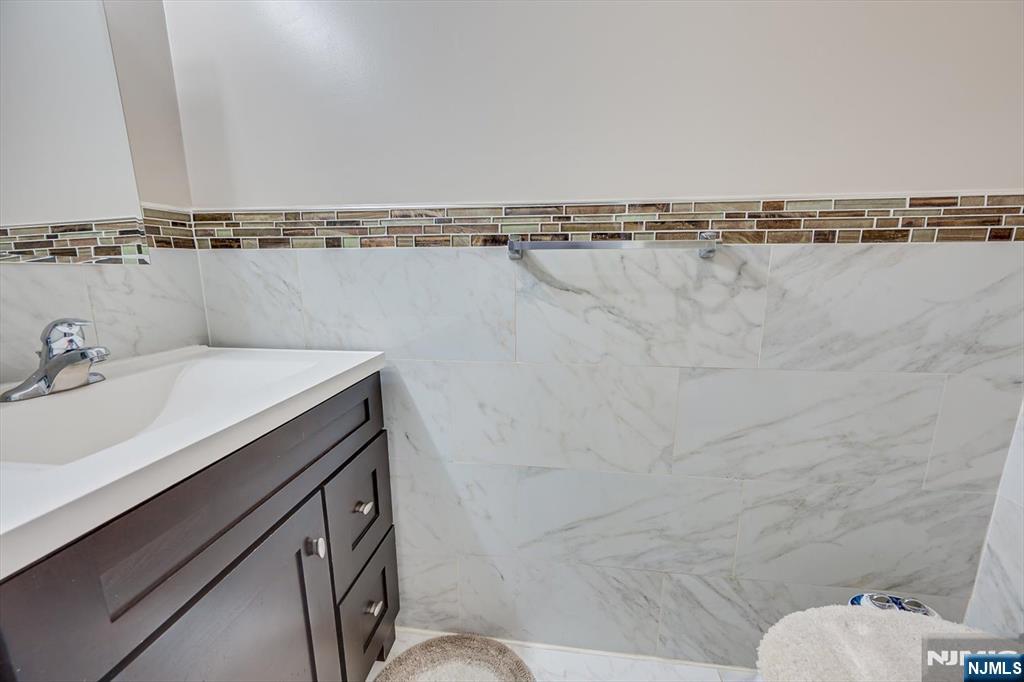 304 Maplecrest Road, Unit 304 Edison, NJ 08820 - Photo 23 of 38 a bathroom with a sink mirror vanity and toilet