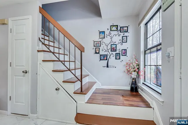 a bedroom with a large bed a chandelier and dresser