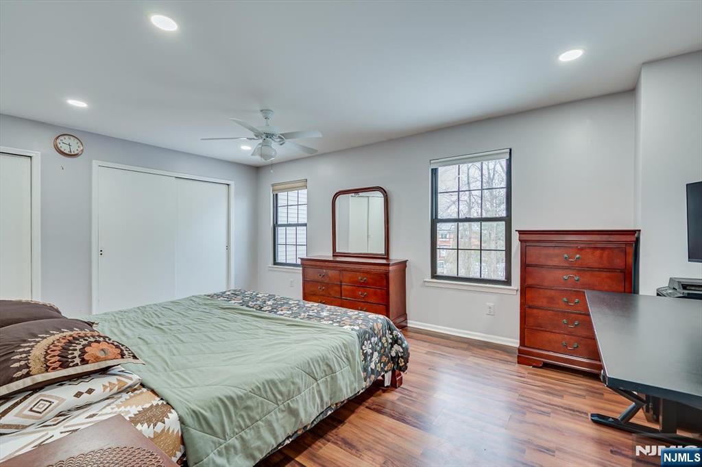 304 Maplecrest Road, Unit 304 Edison, NJ 08820 - Photo 25 of 38 a bedroom with a large bed a chandelier and dresser