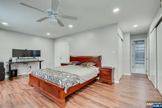 a bedroom with bed tv and window