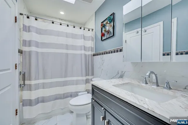 a view of a livingroom with fireplace window and wooden floor