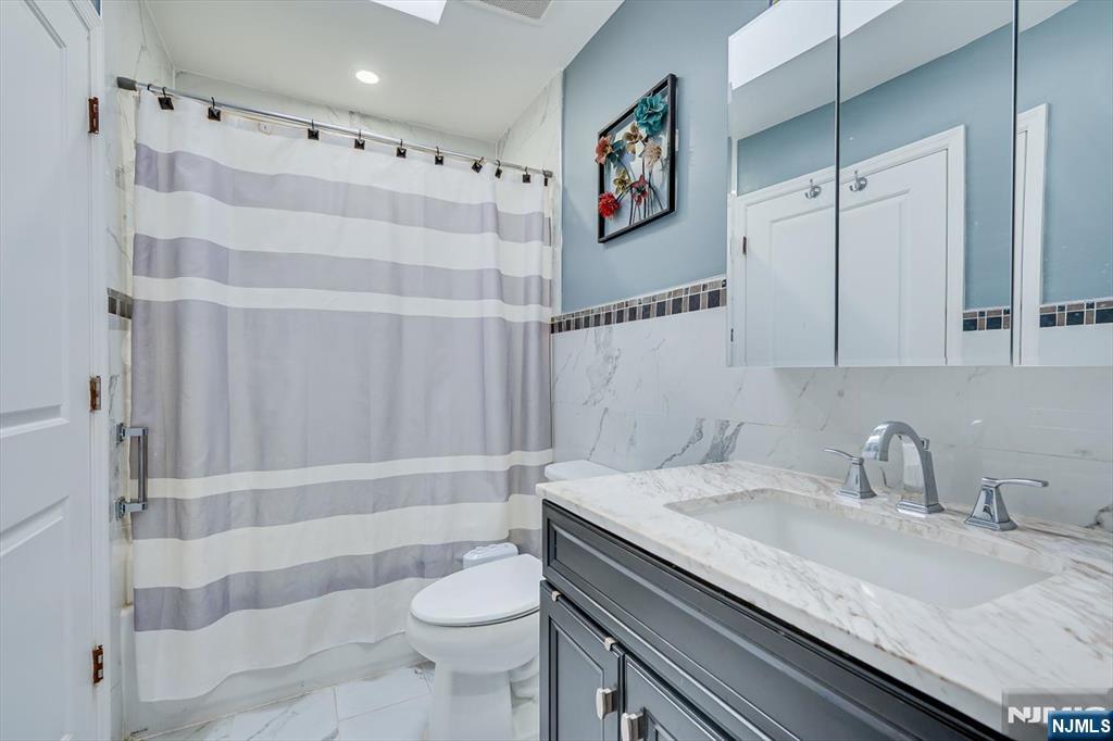 304 Maplecrest Road, Unit 304 Edison, NJ 08820 - Photo 28 of 38 a bathroom with a sink a toilet and shower