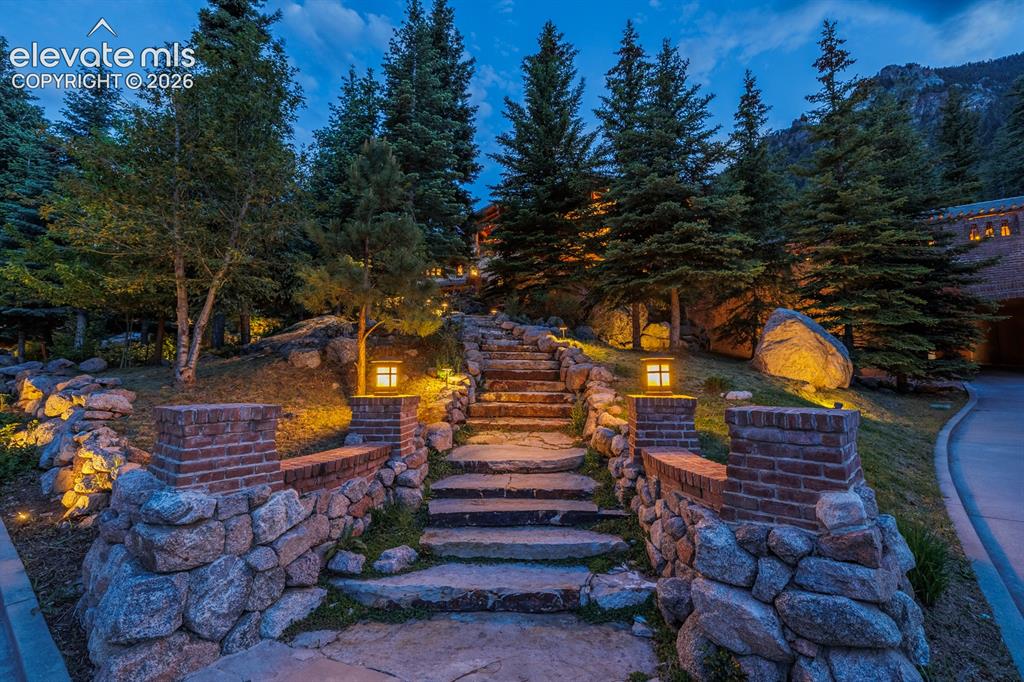 4530 Governors Point Colorado Springs, CO 80906 - Photo 5 of 49 Use of natural Colorado stone leading up this exterior stairway to the home and on the several outdoor terraces and walk ways