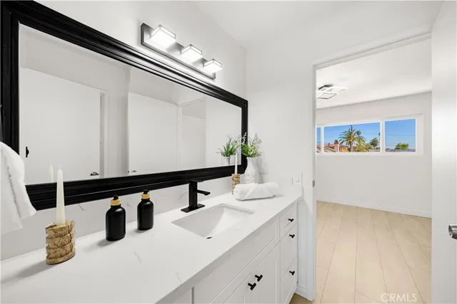 a bathroom with a double vanity sink and mirror