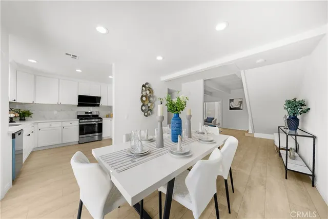 a view of a dining room with furniture and wooden floor