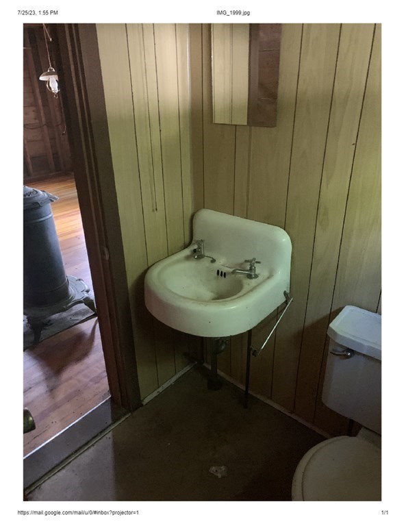 46 Dusty Road Erving, MA 01344 - Photo 7 of 14 a bathroom with a sink a toilet and a mirror