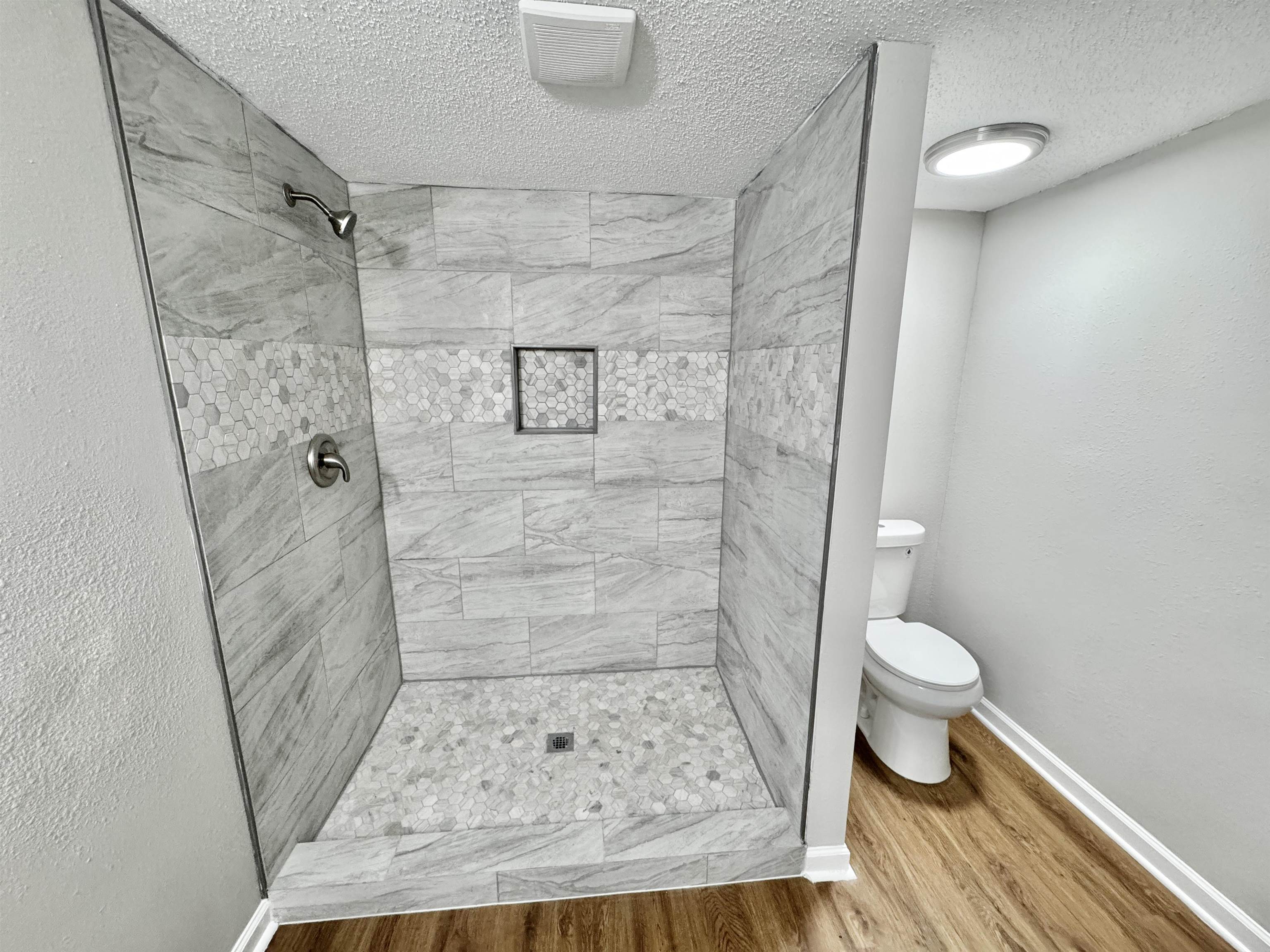 7881 Sherman Road Millington, TN 38053 - Photo 12 of 30 a bathroom with a granite countertop shower and a toilet