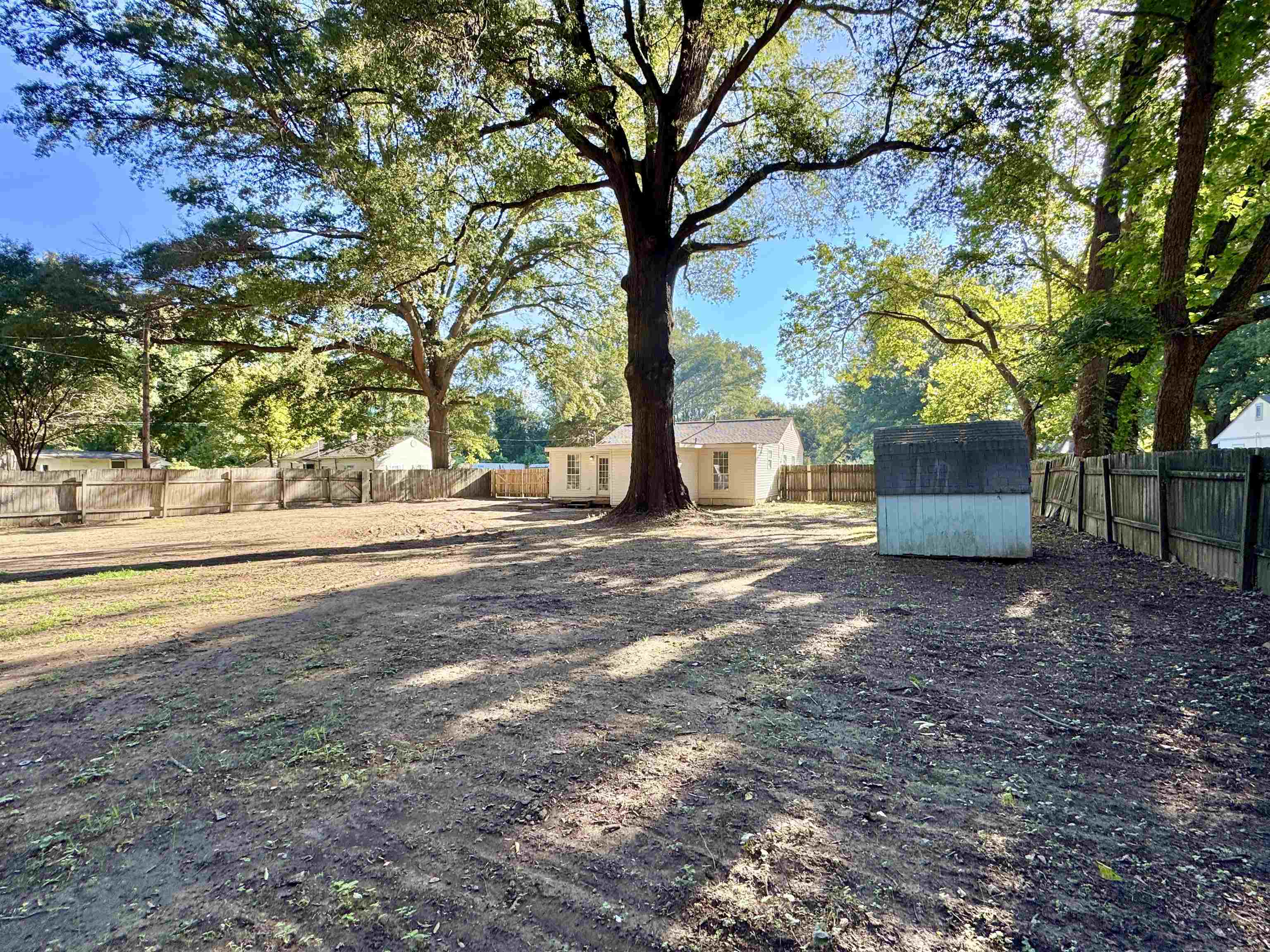7881 Sherman Road Millington, TN 38053 - Photo 25 of 30 a backyard of a house with trees and outdoor seating