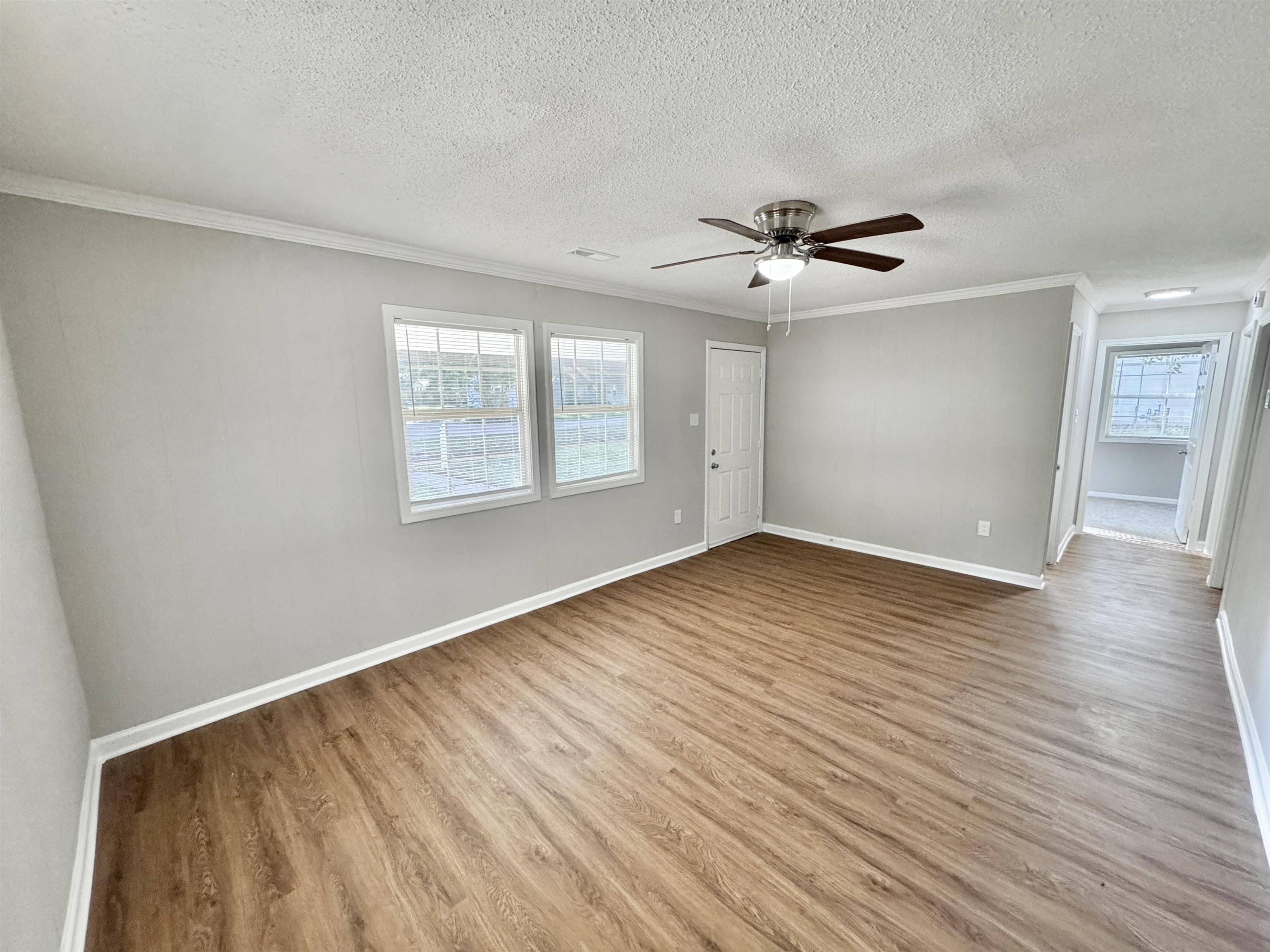 7881 Sherman Road Millington, TN 38053 - Photo 6 of 30 wooden floor in an empty room with a window
