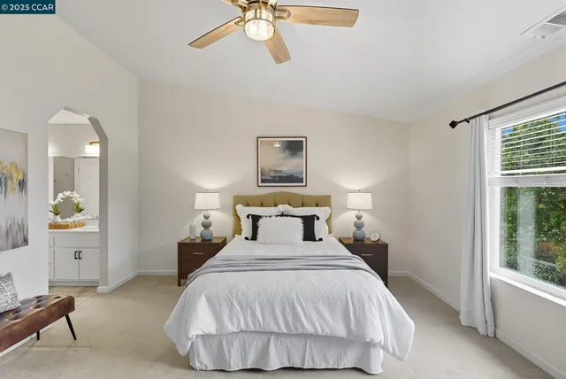 a bedroom with a bed and a window