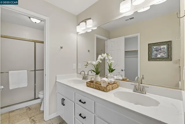 a bathroom with a sink a large mirror and a shower