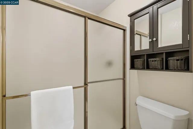 a bathroom with a toilet and a shower