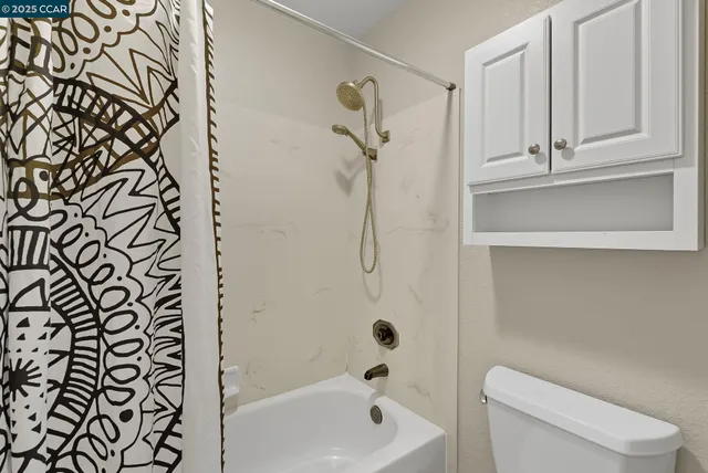 a bathroom with a shower a toilet and sink