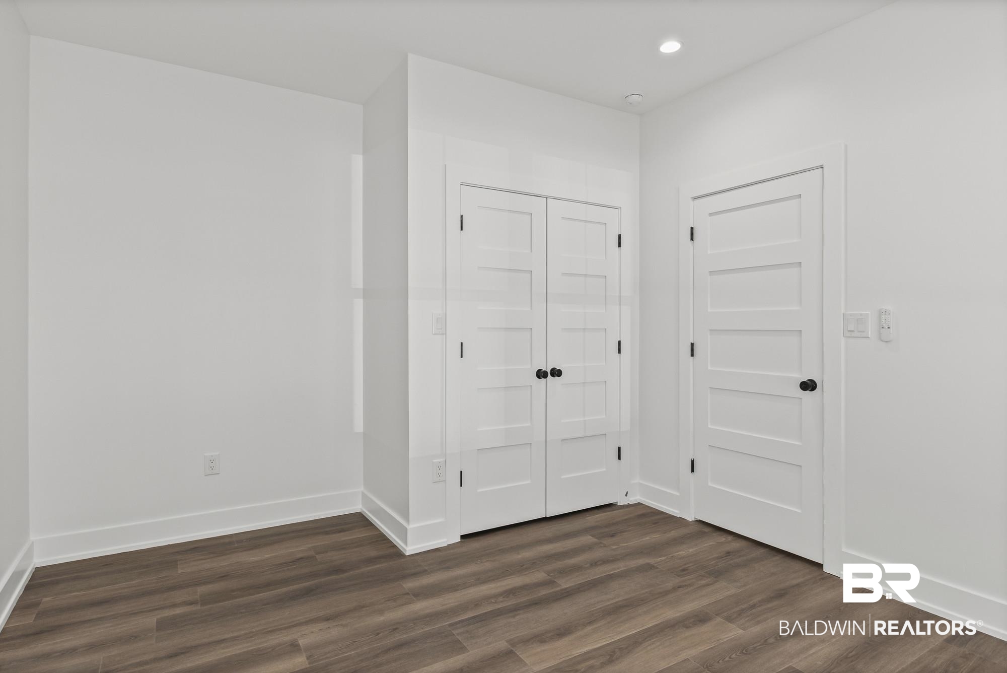 10180 Pineview Drive Foley, AL 36535 - Photo 27 of 47 Unfurnished bedroom featuring dark wood-type flooring and a closet