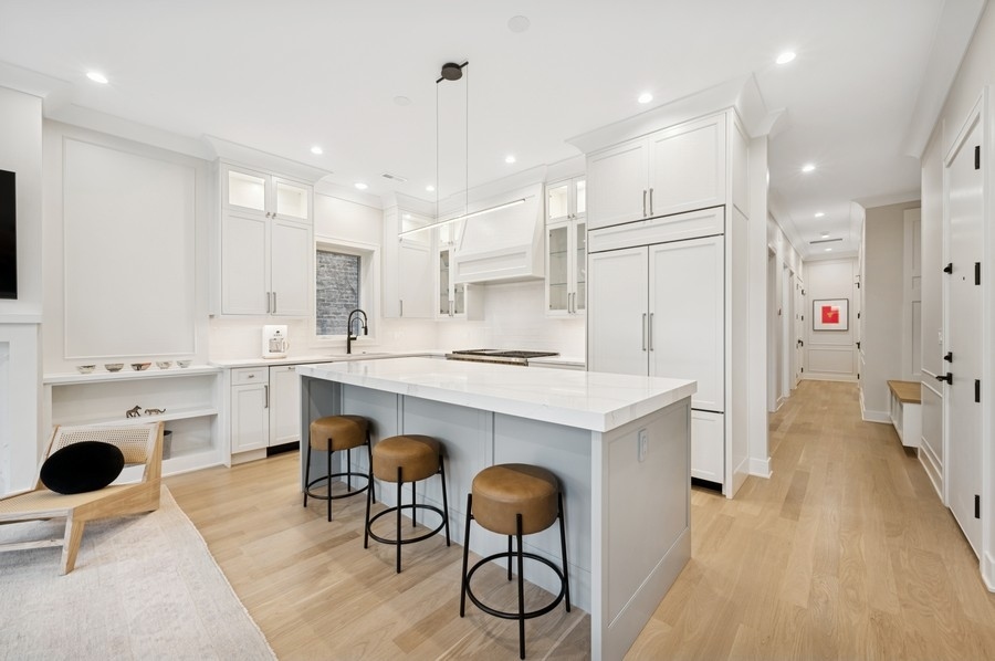 2136 North Cleveland Avenue, Unit 2 Chicago, IL 60614 - Photo 12 of 38 a kitchen with a dining table chairs sink refrigerator and cabinets