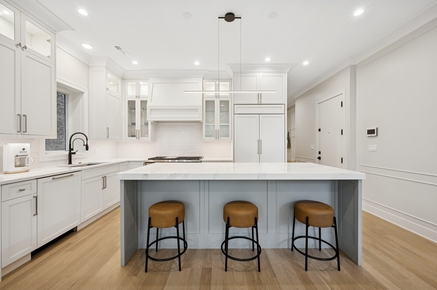 2136 North Cleveland Avenue, Unit 2 Chicago, IL 60614 - Photo 13 of 38 a kitchen with white cabinets and chairs