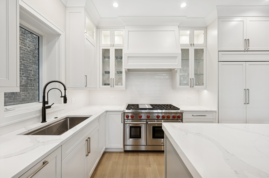 2136 North Cleveland Avenue, Unit 2 Chicago, IL 60614 - Photo 14 of 38 a kitchen with stainless steel appliances a white stove top oven sink and cabinets