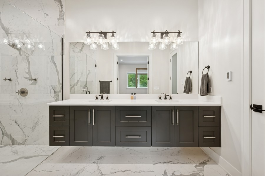 2136 North Cleveland Avenue, Unit 2 Chicago, IL 60614 - Photo 28 of 38 a bathroom with a double vanity sink and a mirror