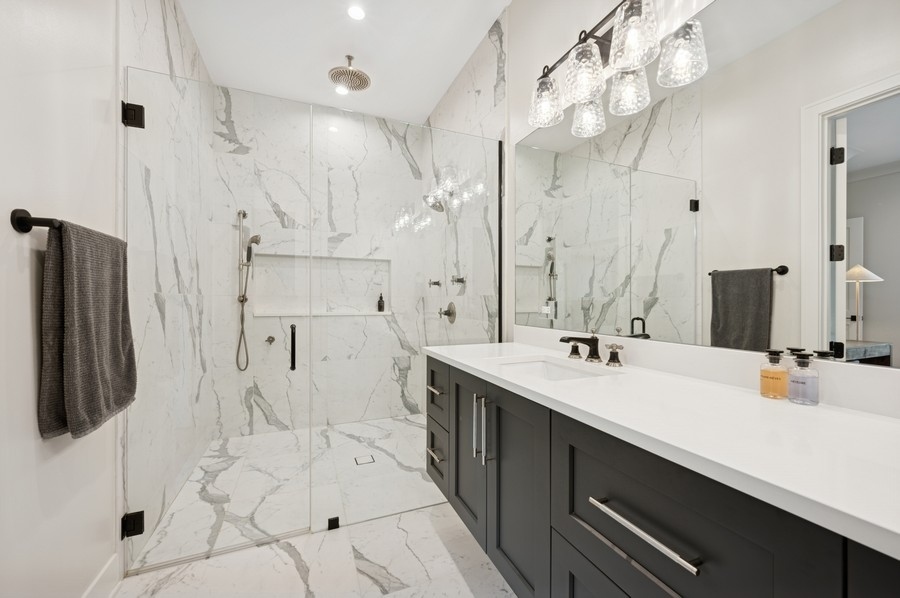 2136 North Cleveland Avenue, Unit 2 Chicago, IL 60614 - Photo 29 of 38 a spacious bathroom with a double vanity sink mirror and shower