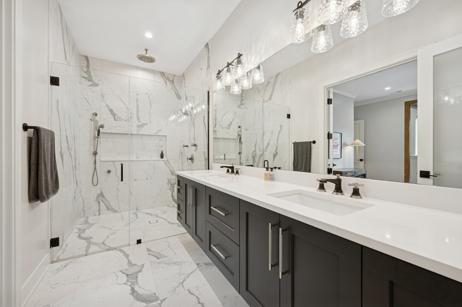 2136 North Cleveland Avenue, Unit 2 Chicago, IL 60614 - Photo 31 of 38 a bathroom with a double vanity sink mirror and shower
