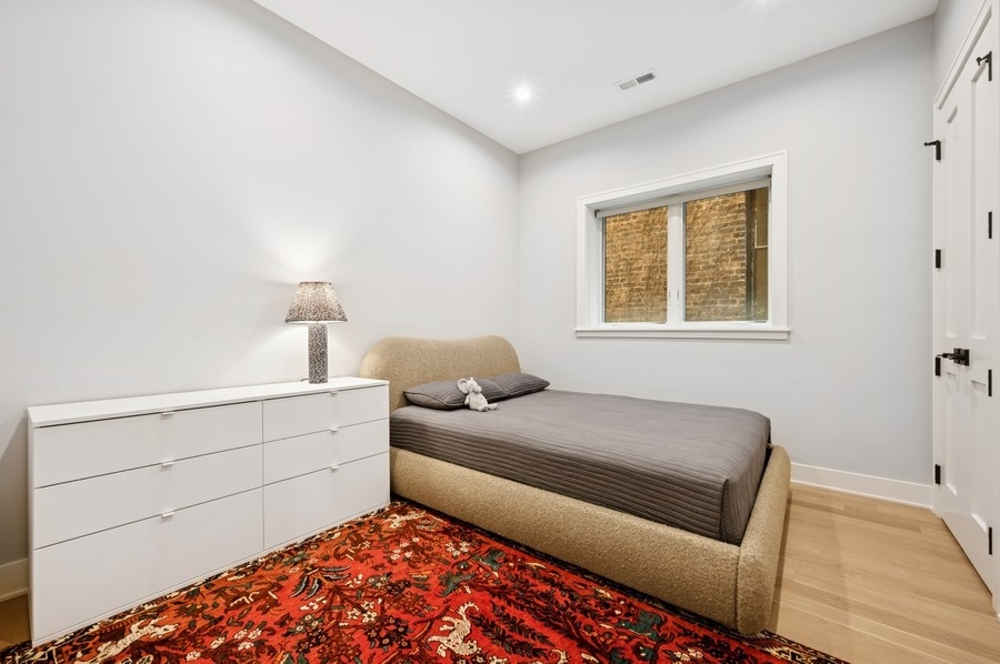 2136 North Cleveland Avenue, Unit 2 Chicago, IL 60614 - Photo 32 of 38 a bedroom with a bed and a window