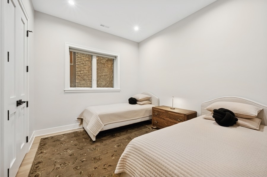 2136 North Cleveland Avenue, Unit 2 Chicago, IL 60614 - Photo 33 of 38 a bedroom with two beds and a window