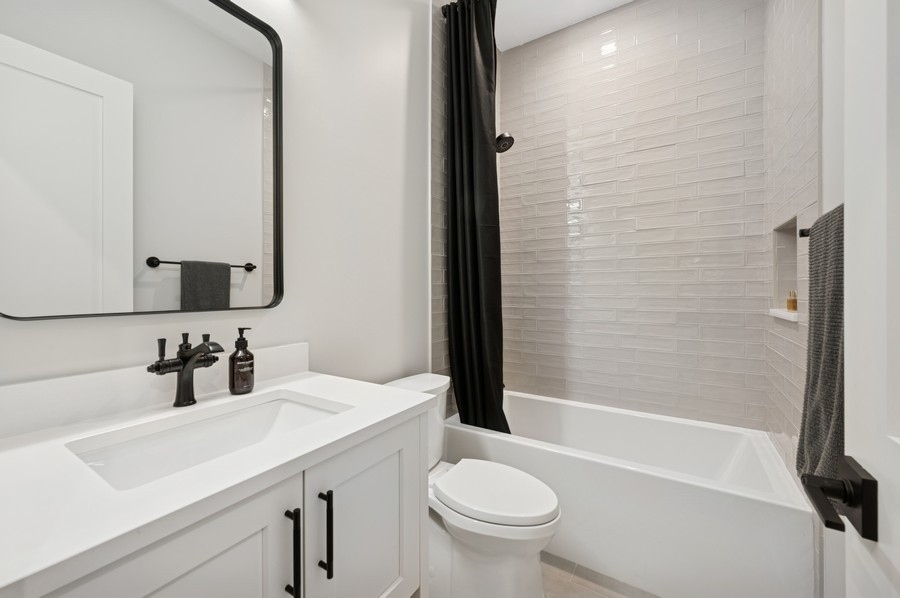 2136 North Cleveland Avenue, Unit 2 Chicago, IL 60614 - Photo 34 of 38 a bathroom with a sink and a mirror