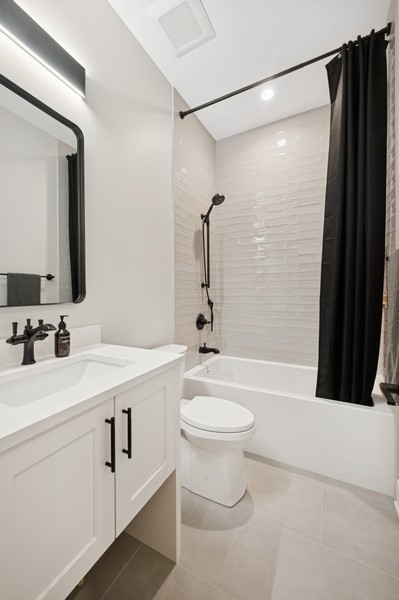 2136 North Cleveland Avenue, Unit 2 Chicago, IL 60614 - Photo 36 of 38 a bathroom with a sink a toilet a mirror a bathtub and shower