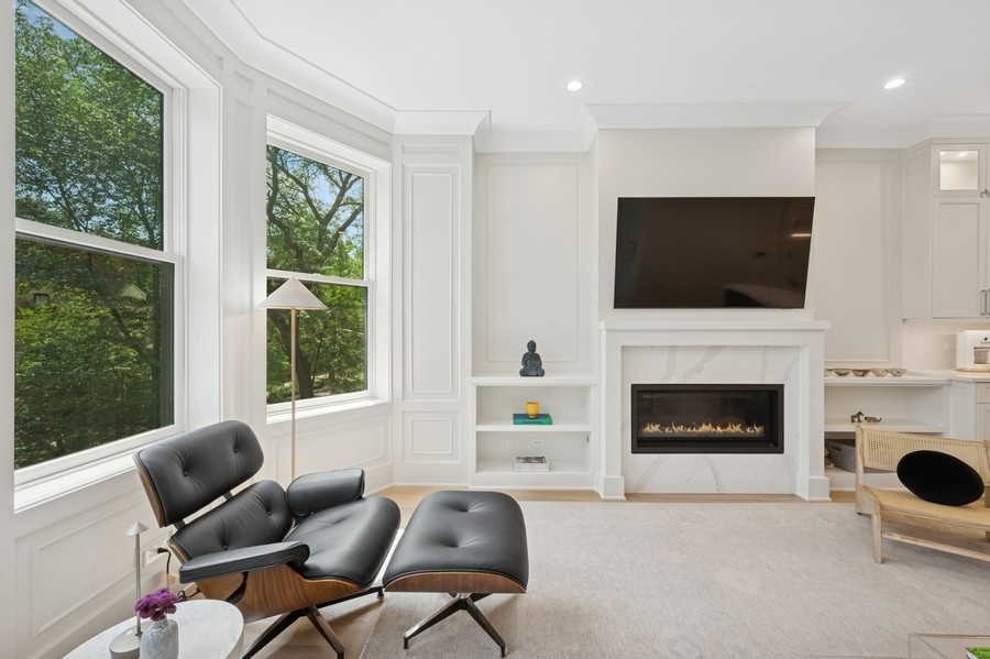 2136 North Cleveland Avenue, Unit 2 Chicago, IL 60614 - Photo 9 of 38 a living room with furniture a flat screen tv and a fireplace