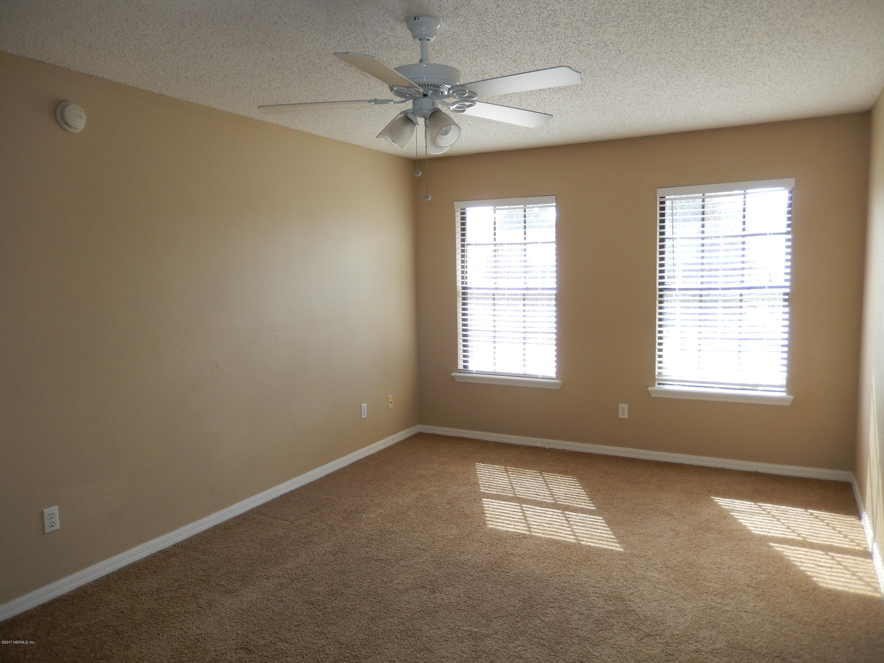 778 Ginger Mill Drive Jacksonville, FL 32259 - Photo 13 of 19 an empty room with a window and a ceiling fan