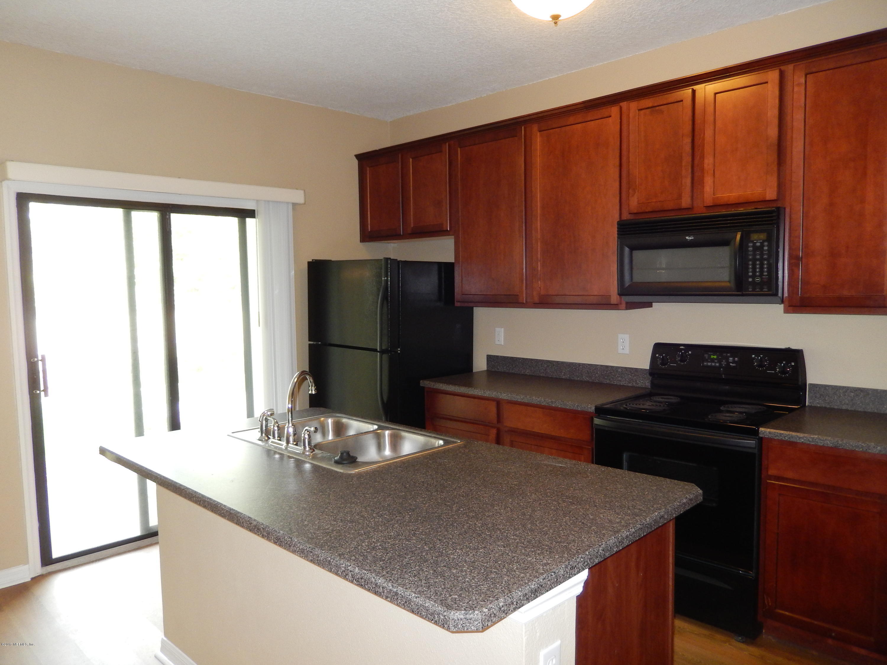 778 Ginger Mill Drive Jacksonville, FL 32259 - Photo 8 of 19 a kitchen with a sink a microwave a stove and refrigerator