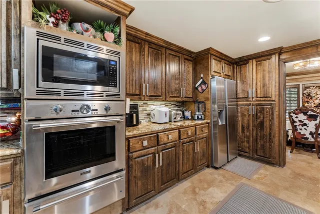 a kitchen with granite countertop cabinets and steel stainless steel appliances