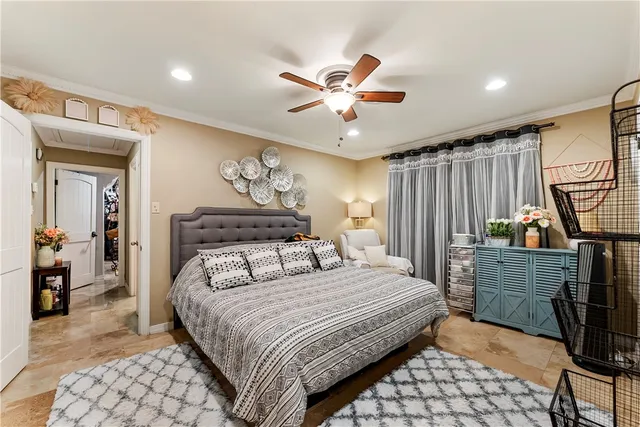 a bedroom with a large bed and a chandelier