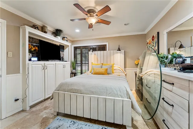 a bedroom with furniture flat screen tv and a view of bedroom