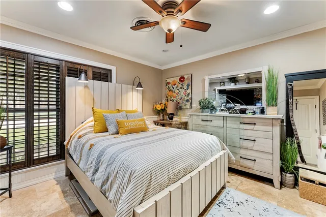 a bedroom with a bed a dresser and flat screen tv