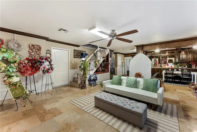 a living room with furniture and flowers