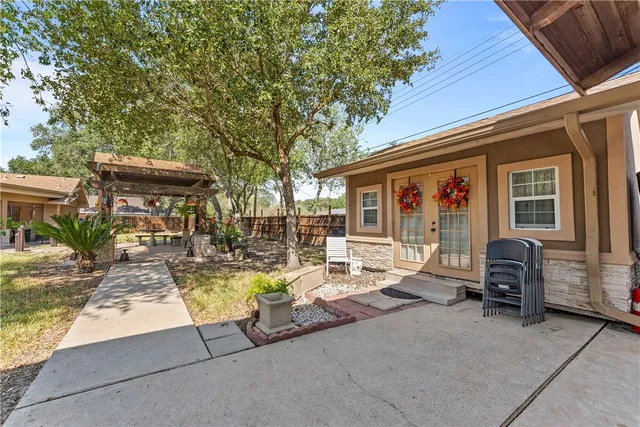 a view of a chair and tables in patio of the house