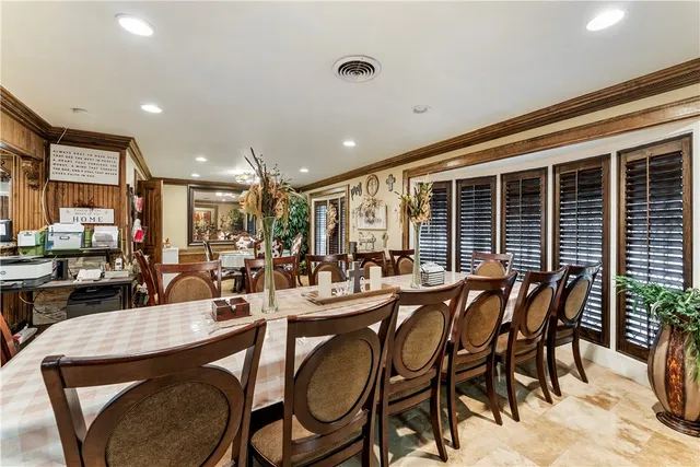 a view of a dining room and livingroom with furniture wooden floor and a rug