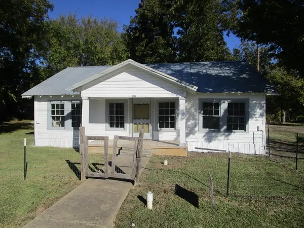 a view of a house with backyard porch and sitting area