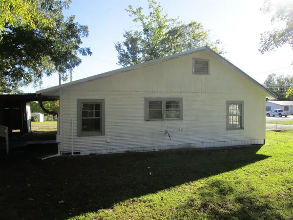 a view of house with backyard