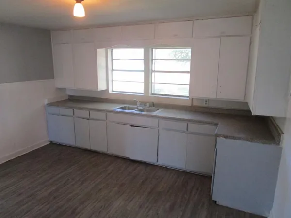 a kitchen with sink cabinets and window